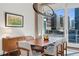 Dining area featuring modern chandelier, hardwood floors, city view, and stylish decor at 1620 Little Raven St # 302, Denver, CO 80202