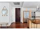 Entryway and modern kitchen featuring stainless steel appliances and island seating at 1620 Little Raven St # 302, Denver, CO 80202