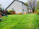 Spacious backyard with lush green lawn, wooden fence, playground, and patio, ideal for outdoor activities at 6002 Alkire Ct, Arvada, CO 80004
