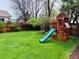 Spacious backyard features a well-maintained lawn and a wooden playset for outdoor fun at 6002 Alkire Ct, Arvada, CO 80004
