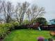Expansive backyard boasts lush lawn, mature trees, and a playset for outdoor enjoyment at 6002 Alkire Ct, Arvada, CO 80004