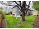 Spacious backyard with a large patio, outdoor seating, a grill, and lush greenery at 6002 Alkire Ct, Arvada, CO 80004