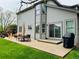 Backyard patio with outdoor dining area, chairs, grill, and plenty of space for entertaining at 6002 Alkire Ct, Arvada, CO 80004