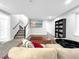 Spacious finished basement area featuring plush carpeting, a television, and a staircase at 6002 Alkire Ct, Arvada, CO 80004
