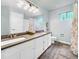 Bright bathroom features dual sinks with wood-look flooring, and a shower/tub at 6002 Alkire Ct, Arvada, CO 80004