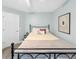 This simple bedroom has an iron bed frame and hardwood flooring at 6002 Alkire Ct, Arvada, CO 80004