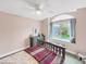 This bedroom has a ceiling fan and a large window seat at 6002 Alkire Ct, Arvada, CO 80004