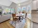 Dining area with hardwood floors, bright bay window, and modern lighting at 6002 Alkire Ct, Arvada, CO 80004