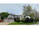 Two-story home featuring a large front yard, attached garage, and well-maintained landscaping at 6002 Alkire Ct, Arvada, CO 80004