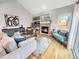 Cozy living room with brick fireplace and vaulted ceilings at 6002 Alkire Ct, Arvada, CO 80004
