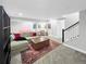 Finished basement with comfortable seating, playful décor, and access to stairs at 6002 Alkire Ct, Arvada, CO 80004