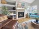 Cozy living room with a fireplace, built-in shelving, and comfortable seating at 6002 Alkire Ct, Arvada, CO 80004
