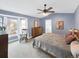 Cozy main bedroom featuring a ceiling fan, large windows, and a rocking chair at 6002 Alkire Ct, Arvada, CO 80004