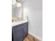 Stylish powder room featuring a modern vanity with gold fixtures at 6002 Alkire Ct, Arvada, CO 80004