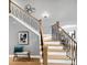 Elegant staircase featuring decorative metal railings and hardwood treads at 6002 Alkire Ct, Arvada, CO 80004