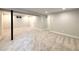 Spacious carpeted basement with modern lighting, fresh paint, and ample room for versatile use at 1853 S Filbert Ct, Denver, CO 80222