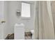 Compact bathroom featuring a modern sink, toilet, and a window for natural light at 1930 E Martin Luther King Jr Blvd, Denver, CO 80205