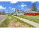 Street view of the home featuring a large yard and a red fence, showcasing its curb appeal at 1930 E Martin Luther King Jr Blvd, Denver, CO 80205