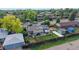 Aerial view of residential property showcasing landscaping, fencing, solar panels and proximity to neighboring homes at 41 S Fenton St, Lakewood, CO 80226