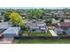 Aerial view showcasing residential property with mature trees, fenced yard, solar panels and the neighborhood at 41 S Fenton St, Lakewood, CO 80226