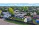 Aerial view of property showing mature trees, fenced yard, solar panels, and street view of the neighborhood at 41 S Fenton St, Lakewood, CO 80226
