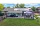 Aerial view of home featuring large backyard with patio, dining area, basketball court, and solar panels on the roof at 41 S Fenton St, Lakewood, CO 80226