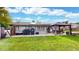 Backyard featuring a patio, barbecue grills, solar panels, a gazebo, and lush green lawn at 41 S Fenton St, Lakewood, CO 80226