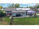 Aerial view of home featuring large backyard with a patio dining area and solar panels on the roof at 41 S Fenton St, Lakewood, CO 80226