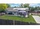 Aerial view of the backyard with a gazebo, patio furniture, barbecue grills, solar panels, and a basketball court at 41 S Fenton St, Lakewood, CO 80226