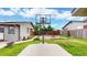 Backyard view including a basketball hoop, a fire pit, a green yard, and a glimpse of neighboring houses at 41 S Fenton St, Lakewood, CO 80226