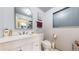 Bright, tidy bathroom features a modern white vanity and ample lighting for a clean, updated feel at 41 S Fenton St, Lakewood, CO 80226