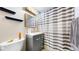Bathroom featuring a gray vanity with drawers and a mirror with an overhead light fixture above at 41 S Fenton St, Lakewood, CO 80226