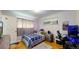 Comfortable bedroom features a gaming setup, air conditioning, and natural lighting for a modern vibe at 41 S Fenton St, Lakewood, CO 80226