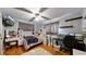 A well-lit bedroom features a plush rug, a vanity, and a bed with a blue patterned blanket at 41 S Fenton St, Lakewood, CO 80226