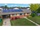 Elevated view of a single-story home featuring solar panels, well-maintained lawn, and charming curb appeal at 41 S Fenton St, Lakewood, CO 80226