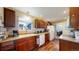 A cozy kitchen featuring warm wood cabinets and a classic double basin sink beneath a sunny window at 41 S Fenton St, Lakewood, CO 80226
