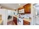 A charming kitchen boasts wooden cabinets, a white stove, and a view into the adjacent dining area at 41 S Fenton St, Lakewood, CO 80226