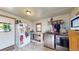 Well-lit laundry room with washer, dryer and storage, includes a refrigerator adorned with stickers at 41 S Fenton St, Lakewood, CO 80226