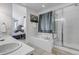 Bathroom featuring a large tub with shower, double sinks, and tile floors at 23525 Painted Hills St, Parker, CO 80138