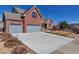 Attractive brick home featuring a spacious three-car garage and inviting curb appeal at 23525 Painted Hills St, Parker, CO 80138