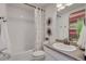 Well-lit bathroom features a shower with decorative curtain, creating a clean and inviting space at 1212 Sugarloaf Ln, Erie, CO 80516