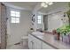 Well-lit bathroom featuring a toilet, vanity with decorative accents, and a shower/tub combination at 1212 Sugarloaf Ln, Erie, CO 80516