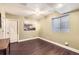 An empty finished basement space with a window for natural light and laminate flooring at 5177 Delphinium Cir, Brighton, CO 80601