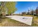 Outdoor basketball court in community with well-maintained surface and mature trees at 5177 Delphinium Cir, Brighton, CO 80601