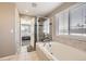 This bathroom has a large tub, shower, and window to the bedroom at 5177 Delphinium Cir, Brighton, CO 80601