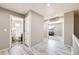 A bright and neutral hallway with doors leading to rooms on the upper level at 5177 Delphinium Cir, Brighton, CO 80601