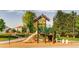 Community playground with climbing structure, slide, and wood chip safety surface at 5177 Delphinium Cir, Brighton, CO 80601