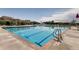 Large community pool with swimming lanes, slide, and lounge area for residents at 5177 Delphinium Cir, Brighton, CO 80601