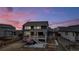 Backyard with hot tub, deck, and basketball court, at dusk at 1210 Horsetail Loop, Elizabeth, CO 80107