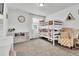 Bright bedroom featuring a bunk bed, built-in shelving, and a comfortable armchair at 1210 Horsetail Loop, Elizabeth, CO 80107